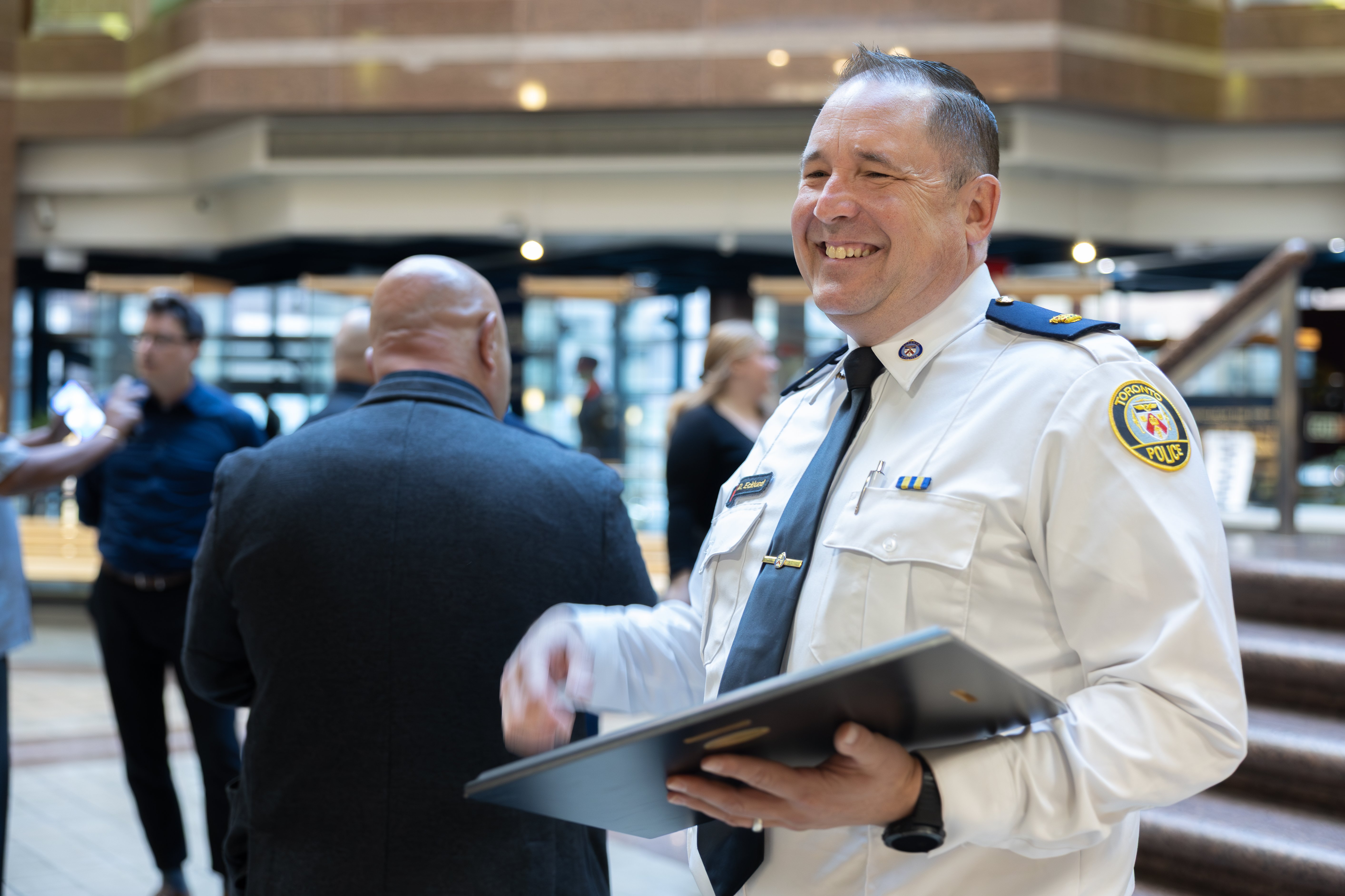 A police officer holding a plaque
