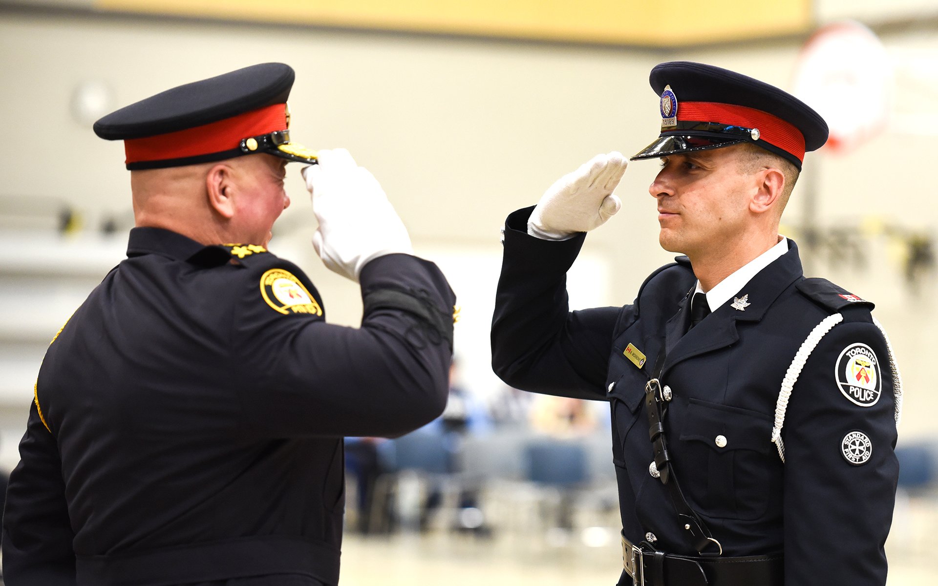 Two police officers saluting