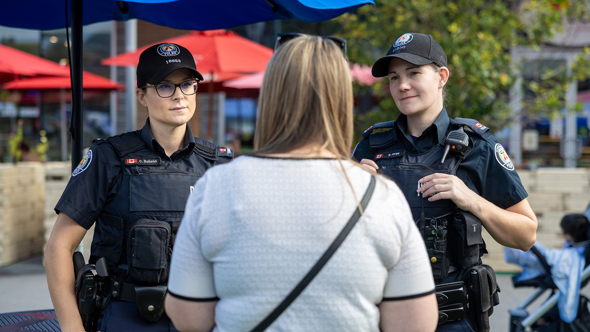 Police officers speak to a person