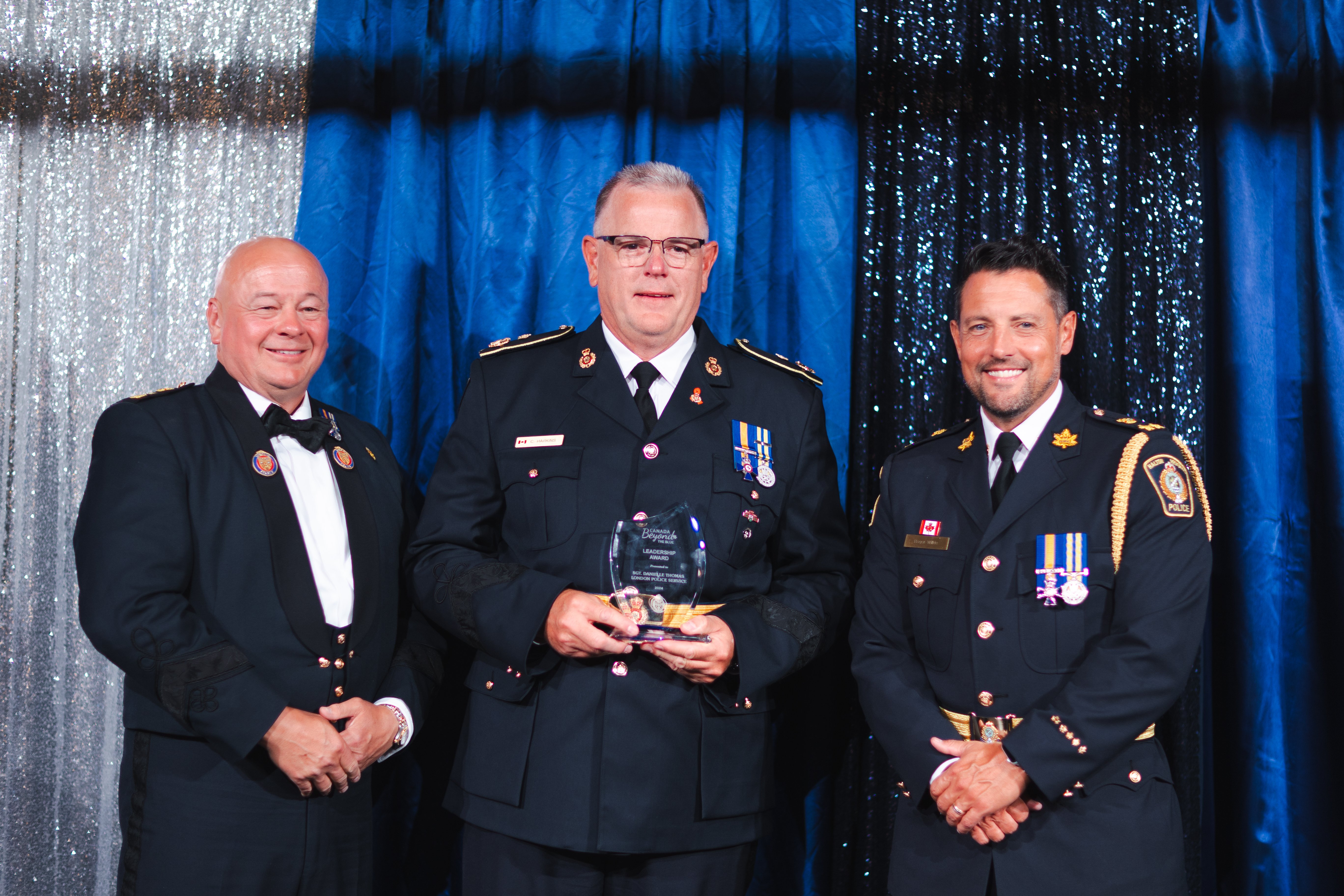 Three police officers stand for a photo