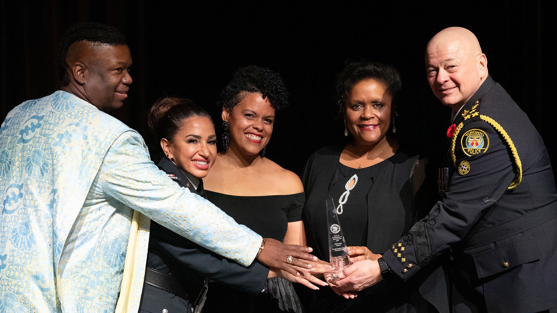 Group of people holding award