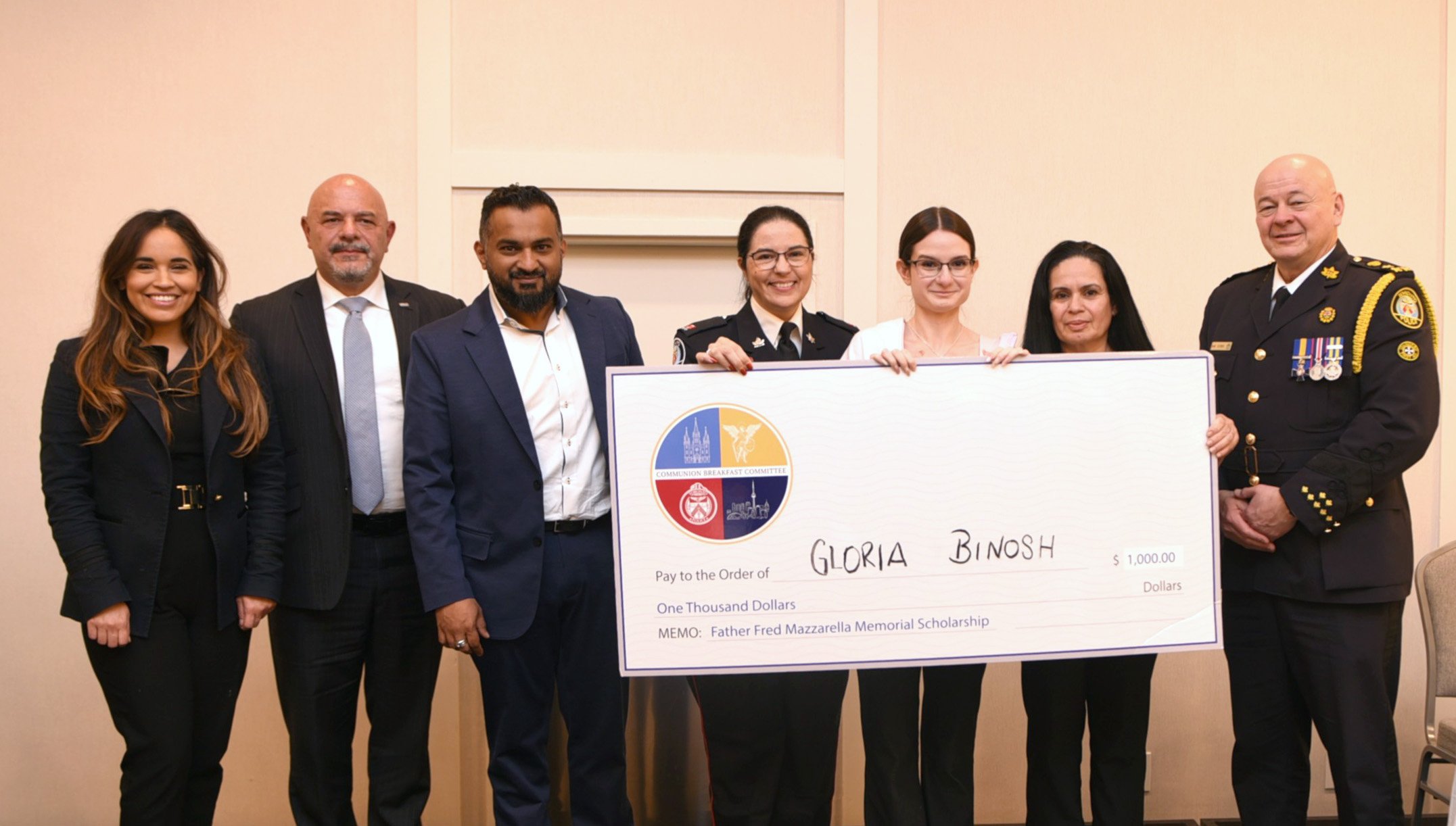 Group of people standing with a cheque