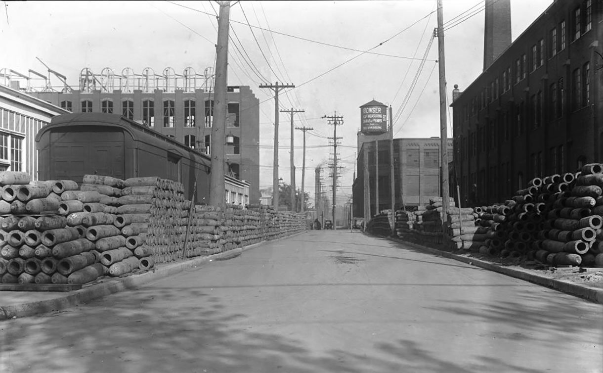 A street with factories and pile of shells on side