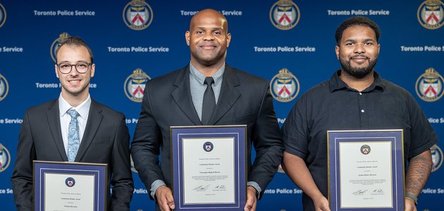 Three people holding certificates