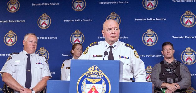 Police officers at a podium