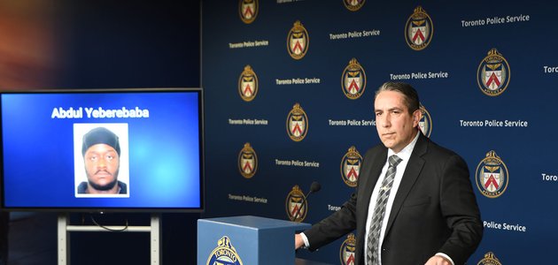 man in a suit stands at the podium lookin on