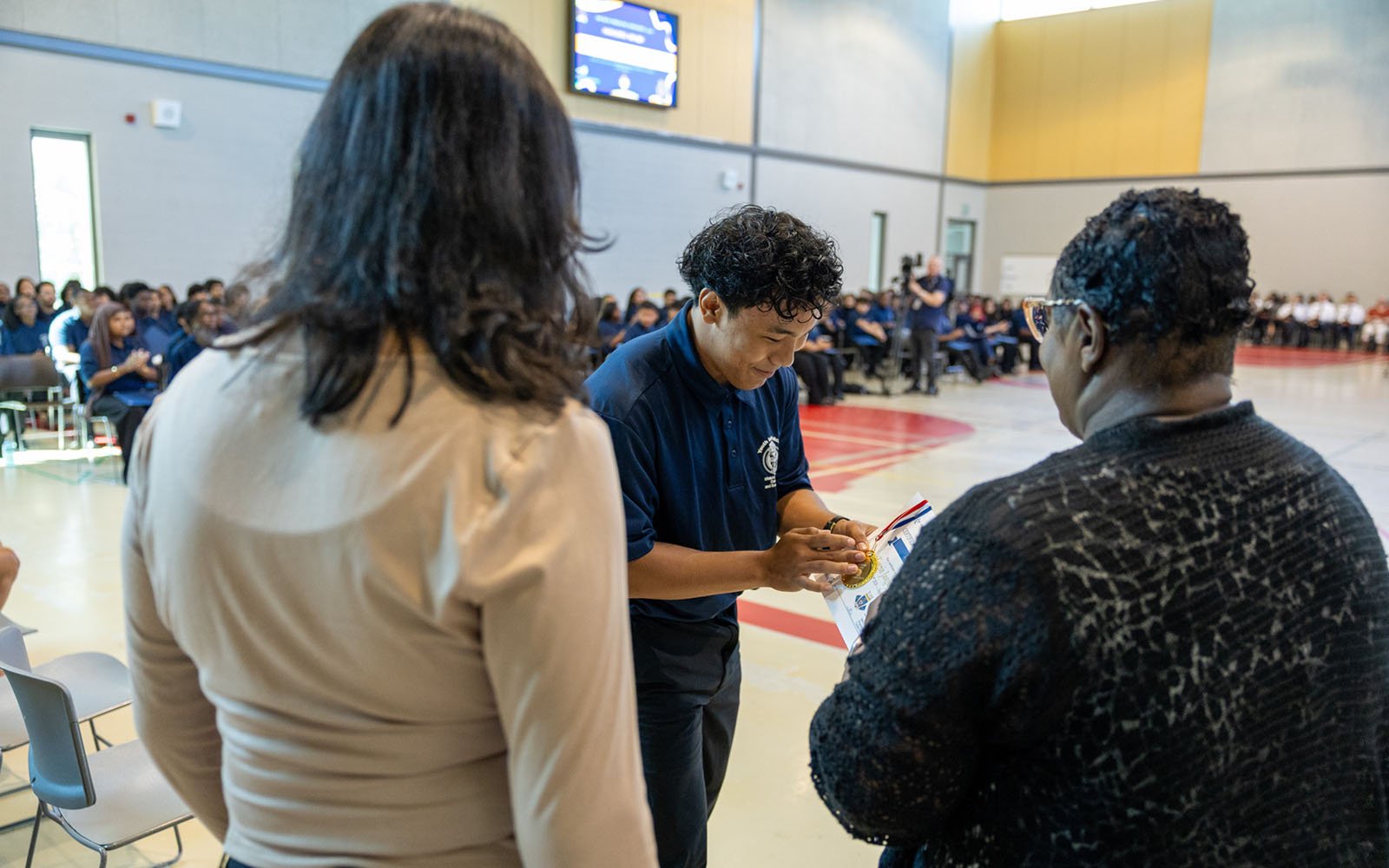 a student is examining his award medal