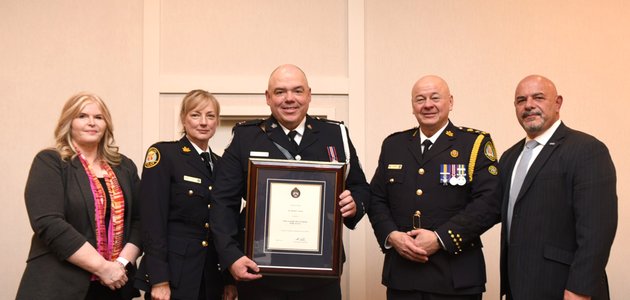 Group of people standing with a certificate