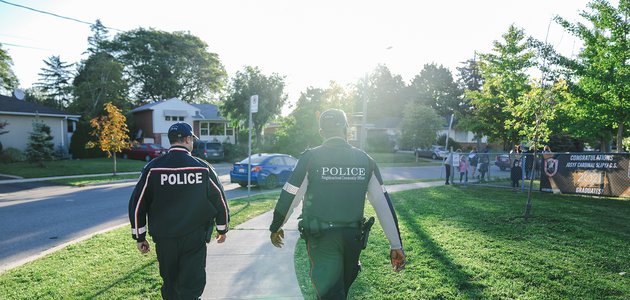 Two officers walking on sidewalk