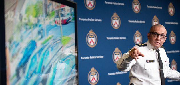 Police officer pointing at a TV