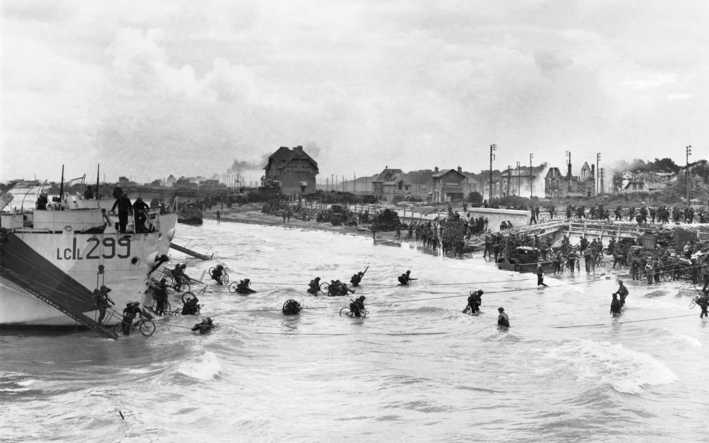 People disembarking a ship onto a beach