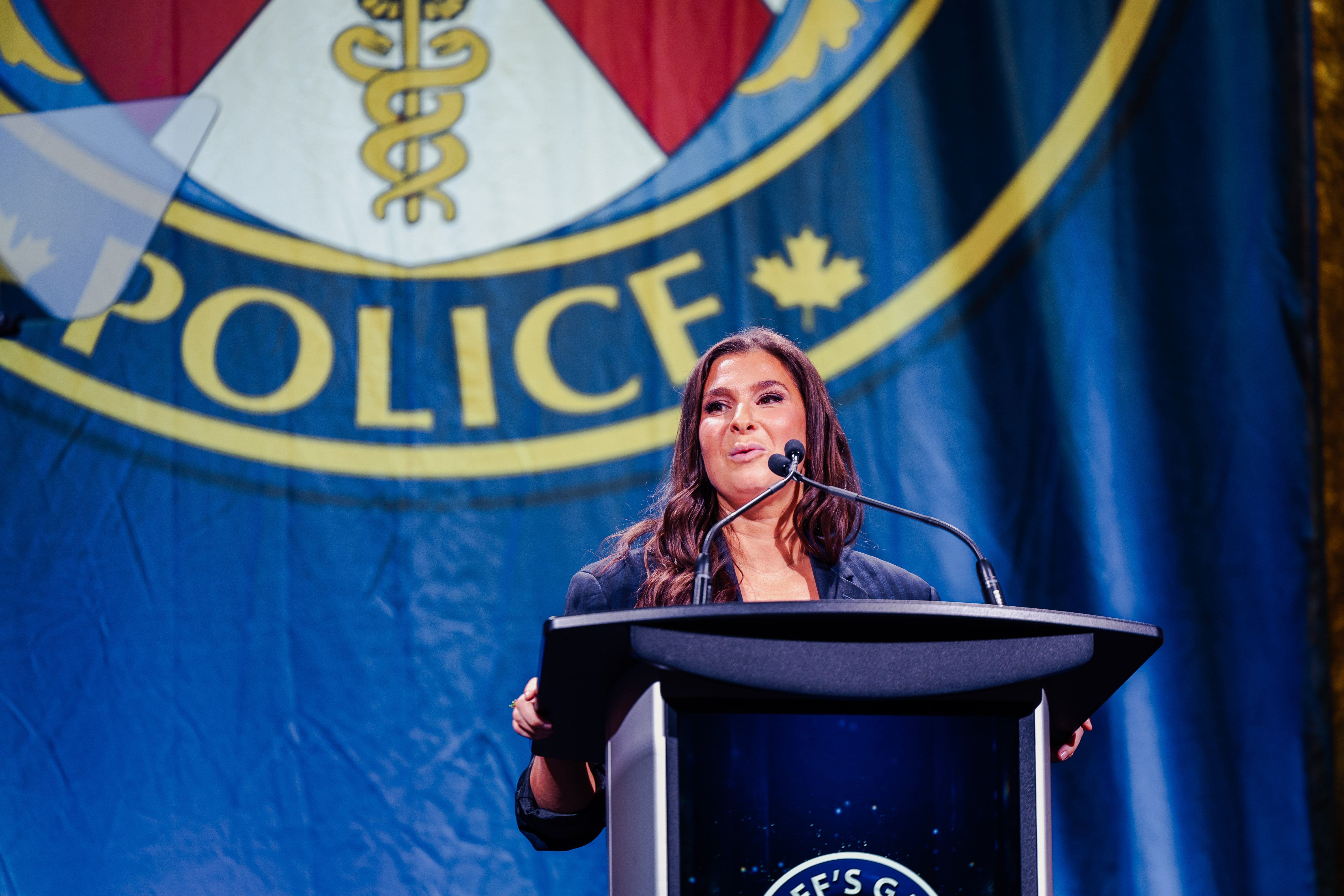 A woman speaks at a podium