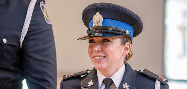 Woman wearing a police uniform smiling