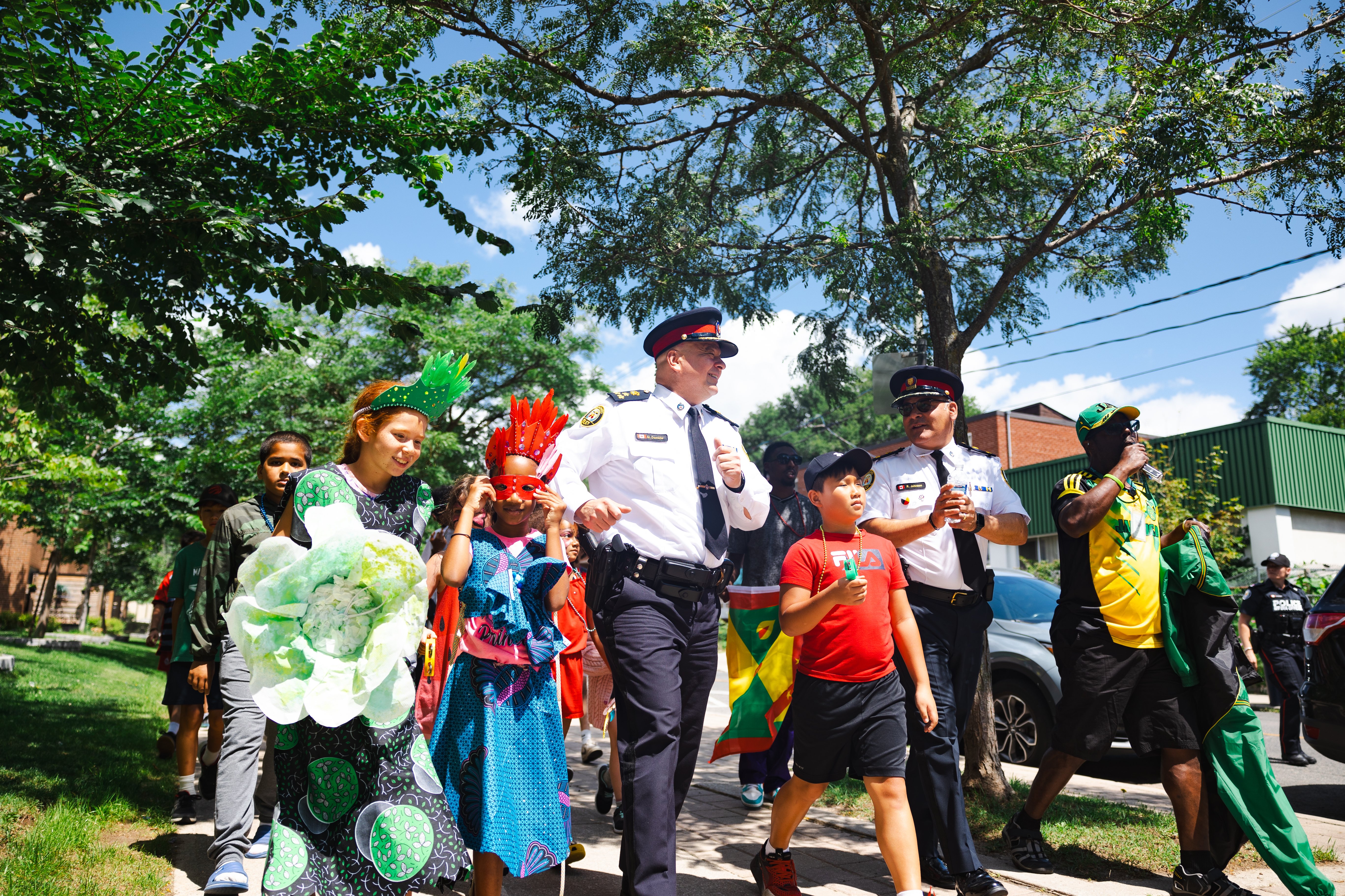 Police officer leads children in a march