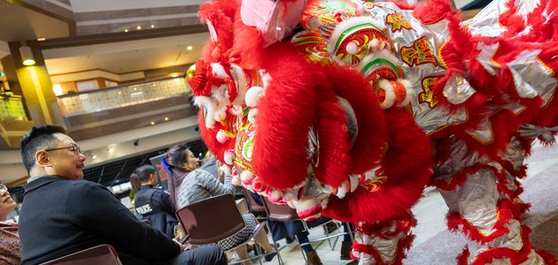 Person seated next to lion costume