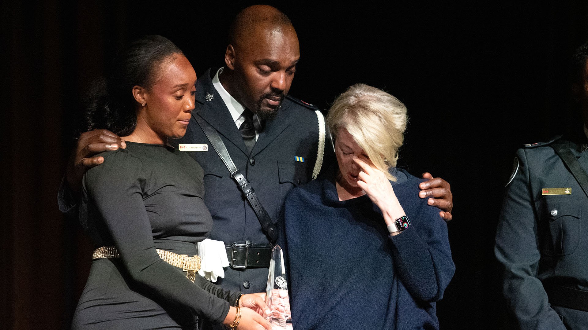 Three people stand together
